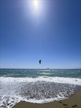 Kitesurfer kite surfer surfing in strong wind and waves rough sea moving sea with inflated sail, in