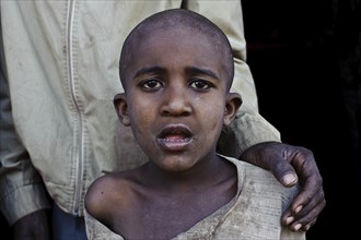 Boy suffering from mental disorder accompanied by his father, Oromia state, Ethiopia, Africa