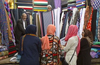 Women buy colourful fabrics at a bazaar in Shiraz on 05.04.2015., Shiras, Iran, Asia