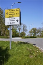 Signposts to the centre, railway station and car train loading station in Niebuell, Nordfriesland