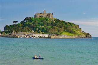Small boat in front of an island, garden and small harbour, Saint Michael's Mount, Penzance,
