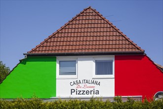 House with pizzeria painted in the Italian national colours, Lilienthal, Lower Saxony, Germany,