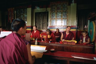 Tibetan buddhist monks praying in a monastery, Swayambhunath, Kathmandu valley, Nepal, Asia