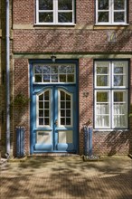 Entrance door and windows on a brick building in Friedrichstadt, Nordfriesland district,