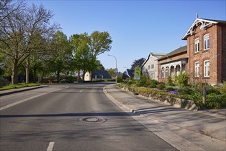 Street and house with front garden in Schafstedt, Dithmarschen district, Schleswig-Holstein,