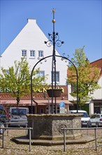 Market fountain from 1613 on the market square in Toenning, Nordfriesland district,