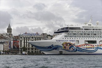 Close-up of the cruise ship 'Norwegian Spirit' in front of the silhouette of the Galata Tower,