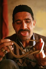 Traditional healer curing people with the help of a snake, Pakistan, Asia