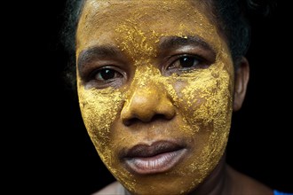 Portrait of a woman with traditional beauty mask, Mananjary, Madagascar, Africa