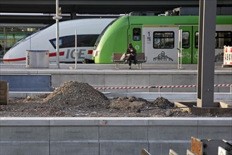Construction site at Dortmund main station, travellers in front of regional train and