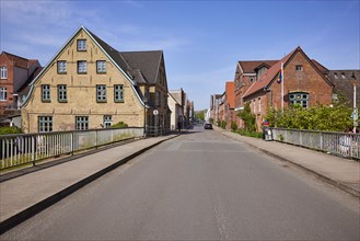 Brueckenstrasse with bridge and historic houses in Friedrichstadt, Nordfriesland district,