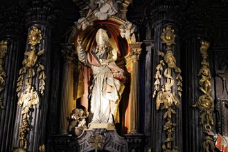 Iglesia San Nicolas de Bari, Baroque statue of a saint with elaborate carvings and details in a