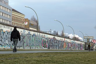 A man walks along the remains of the Berlin Wall, the East Side Gallery, 20/02/2014