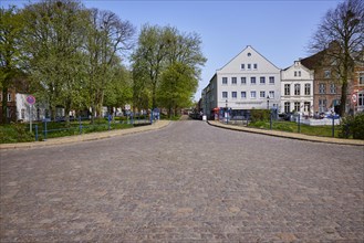 The Great Bridge with cobbled street, park and historic houses in Friedrichstadt, Nordfriesland