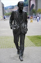Sculpture of a walking man in a suit RAMON RUBIAL CAVIA, Presidente del PSOE 1906-1999, with people