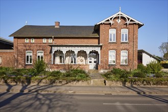 Brick building with front garden in Schafstedt, Dithmarschen district, Schleswig-Holstein, Germany,