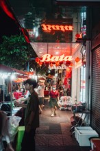 The red illuminated sign of the restaurant on Bangkok's streets in China Town lights up the night