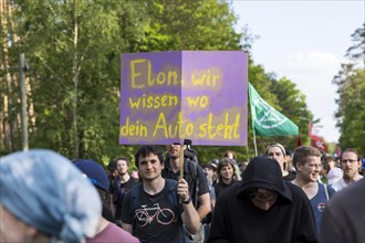 Participants with sign Elon, we know where your car is at the demonstration Wasser. Forest. Justice