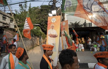 Bharatiya Janata Party (BJP) supporters arrives to to see a roadshow of Union Home minister Amit