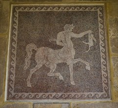 Ancient floor mosaic with a depiction of a centaur, complex stone setting and mythological scenes,