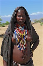 South Ethiopia, in a village of the Arbore or Erbore people at Lake Stefano, young woman wearing