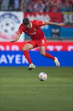 Football match, acrobatic posture with ball by Eren DINKCI 1. FC Heidenheim, football stadium