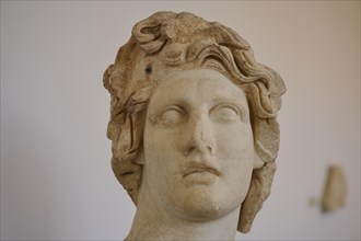 Helios, sun god, close-up of a damaged marble head with wavy hair, ancient aesthetics, interiors,