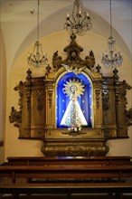 Iglesia San Nicolas de Bari, Madonna with halo on a golden altar against a blue background with