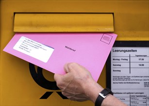 Postal ballot, letterbox, insert ballot paper envelope, light red, pink, European elections,