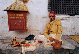 Hindu priest waiting for devotees, applying tilak to assert their devotion, Pashupatinath, Nepal,