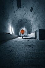 Lone figure in safety clothing in a tunnel, tunnel construction Hermann Hessebahn, Ostelsheim,