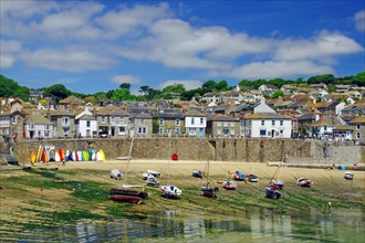 Beach with boats lying on a sandy beach, Mousehole, Cornwall, Great Britain