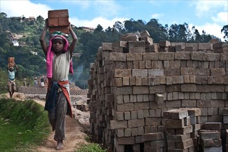 Girl working in a brickyard, Fianarantsoa, Madagascar, Africa