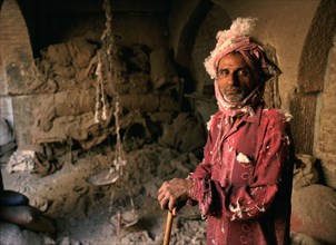 Portrait of a man making woollen mattresses, dirty and dusty work, Bikaner, Rajasthan, India, Asia