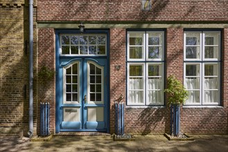Entrance door and windows on a brick building in Friedrichstadt, Nordfriesland district,