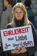 Participant in a silent demonstration for the hunger strikers. Her poster reads Honesty for the