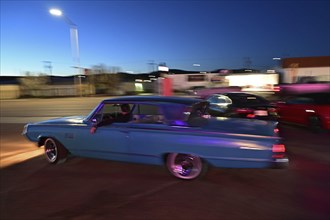 A 1964 Mercury Monterey turns onto Route 66 in the evening light, Gallup, New Mexico