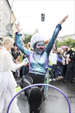Dancer of the CABUWAZI children's and youth circus with hoops at the street parade of the 26th