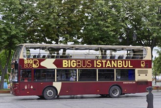 A red double-decker sightseeing bus from Big Bus Istanbul, parked on a street corner, Istanbul