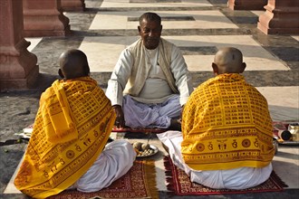 Hindu men performing a dead ancestors ritual, puja held by a brahman, Gaya, Bihar, India, Asia