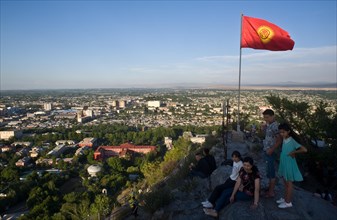View of Osh from the sacred mountain Sulaiman too, Kyrgyzstan. The Kyrgyzstan flag is fluttering in