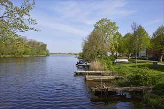 Jetties for pleasure craft on the Westersielzug with the Treene in the background in