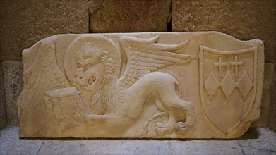 Lion of St Mark, Crispi family crest, A stone relief shows a winged lion and a coat of arms with