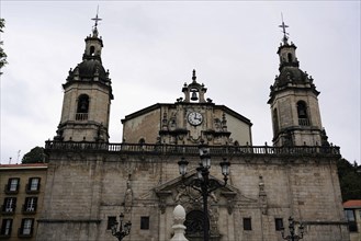 Iglesia San Nicolas de Bari, Baroque church facade with two towers and clock in the centre, Old