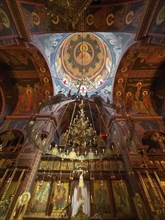 Chancel interior of orthodox church with in the background chandelier chandelier under dome of