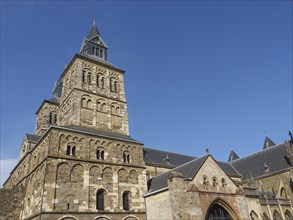 Complete Romanesque stone church under a blue sky, Maastricht, Netherlands