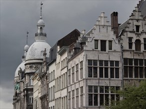 Row of old buildings under a cloudy sky, creating a gloomy atmosphere, Historic buildings on the