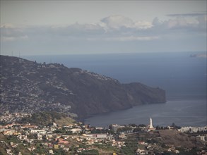 A town on the coast with hills and the sea in the background, Madeira, Portugal, Europe