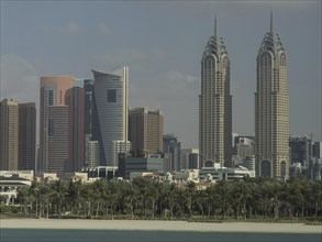 City with modern skyscrapers and tropical vegetation along the coast, Dubai, Arab Emirates