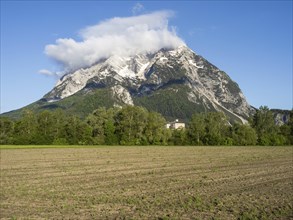 Farmland, behind the Grimming and Trautenfels Castle in the morning light, near Irdning, Styria,